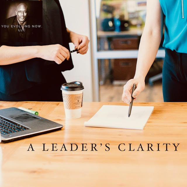 a leaders clarity, people gesturing to a notepad with pens