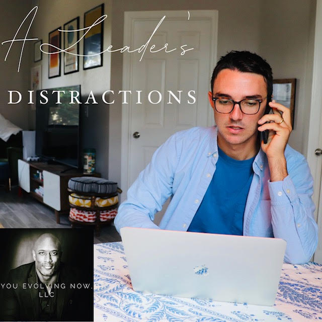 a leaders distractions, young man sitting at a dinner table on both a laptop and phone